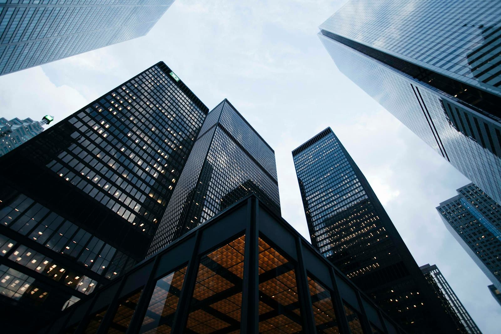 Office towers seen from street level against an overcast sky